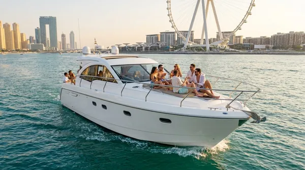 Friends on a small motor yacht off JBR with Ain Dubai behind